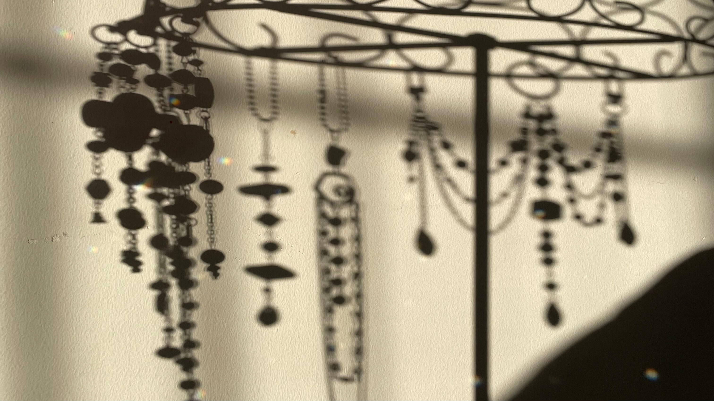 CBTT Shadows cast by handmade hanging objects from the Collected by the Tide collection.